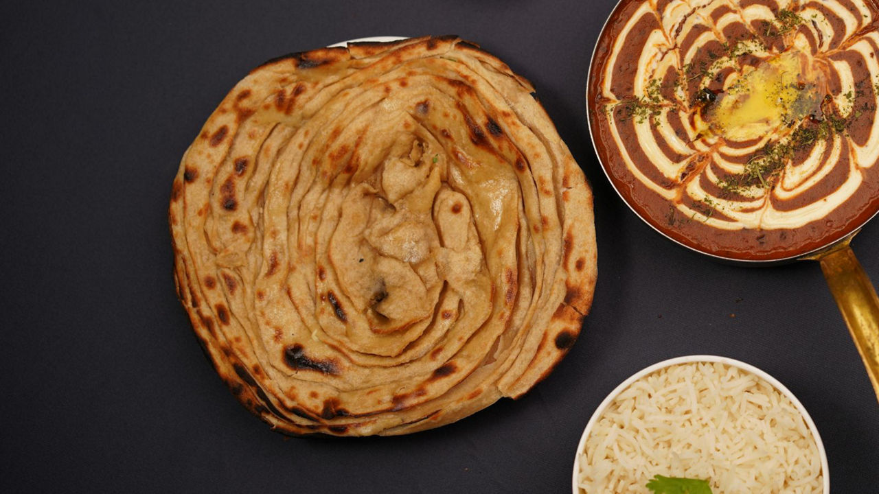 Indian meal with paratha, curry, and rice
