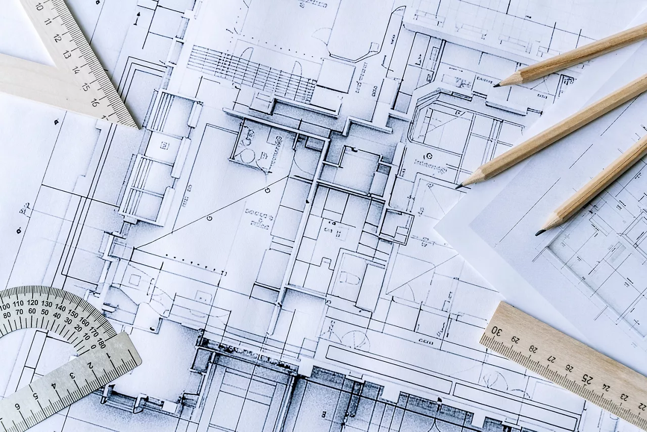 Architectural engineering design plan drawing on the table. Architect's work on table in studio. Construction design and plan