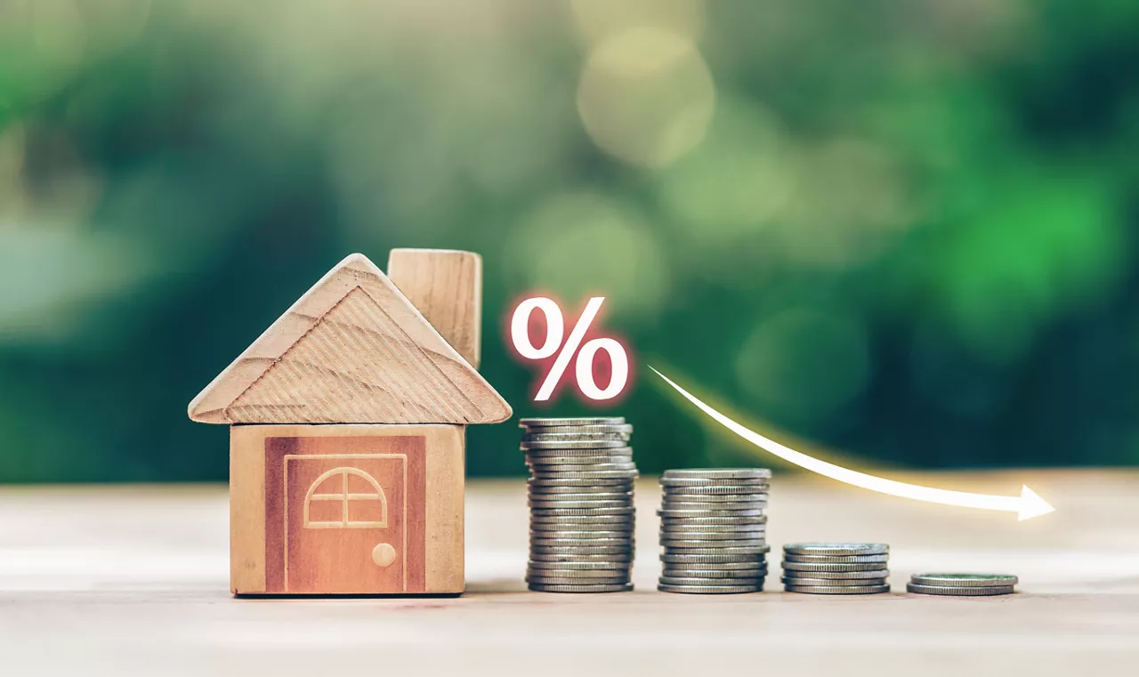 House and coins place on the wood table is ladder with white illustration shows decreasing of interest rates. planning savings money of coins to buy a home concept for property ladder, mortgage.