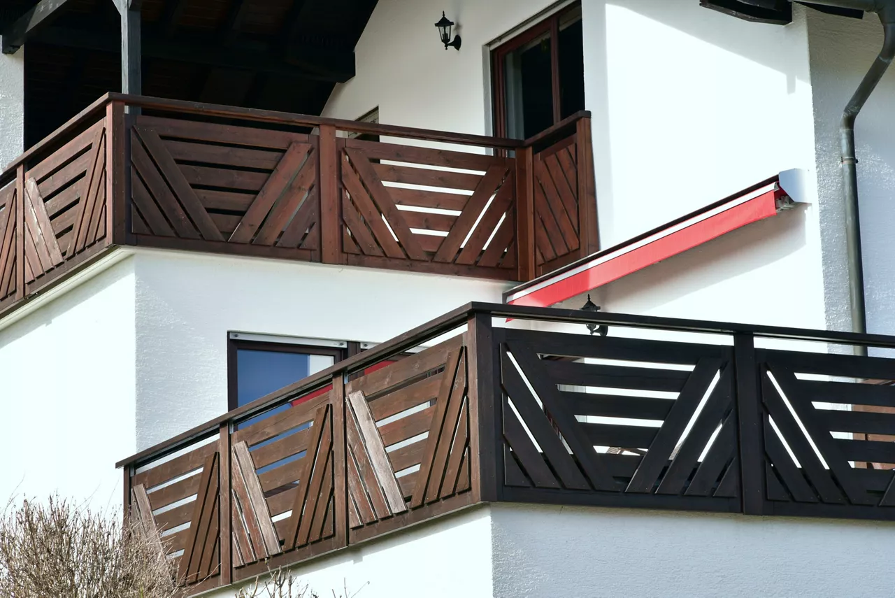 Balcony with privacy protection Screen of varnished wooden Planks at the Front of a residential Building