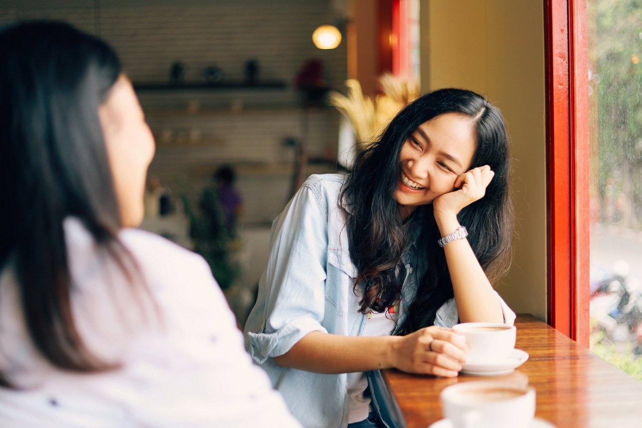 Young happy Asian couple at a cafe