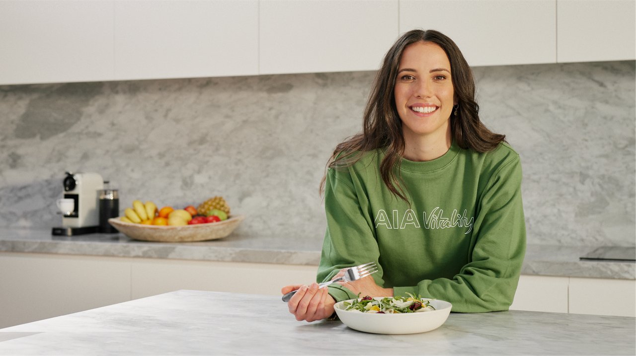 a woman having food on a table