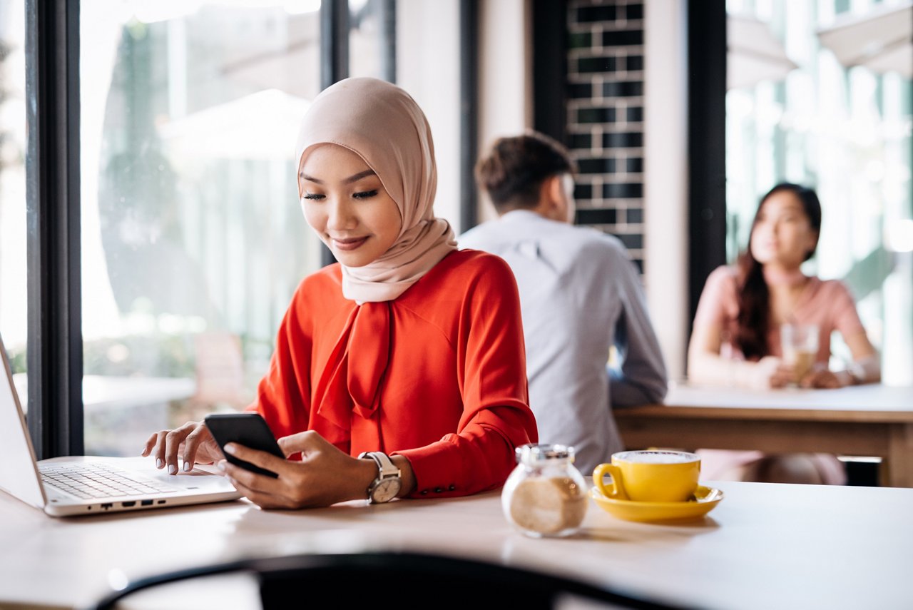Young muslim lady working at a cafe. 