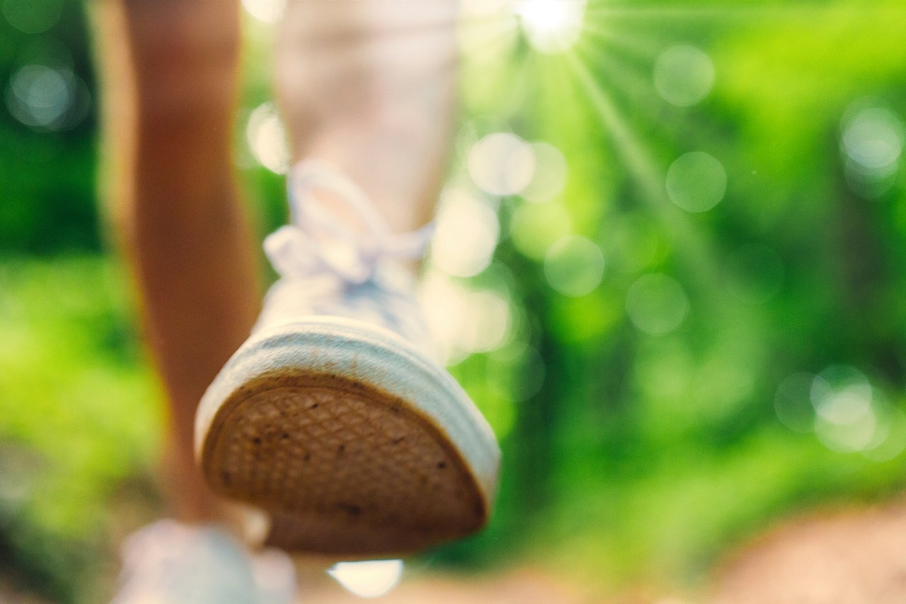 A close-up of someone's sneaker while walking outdoors