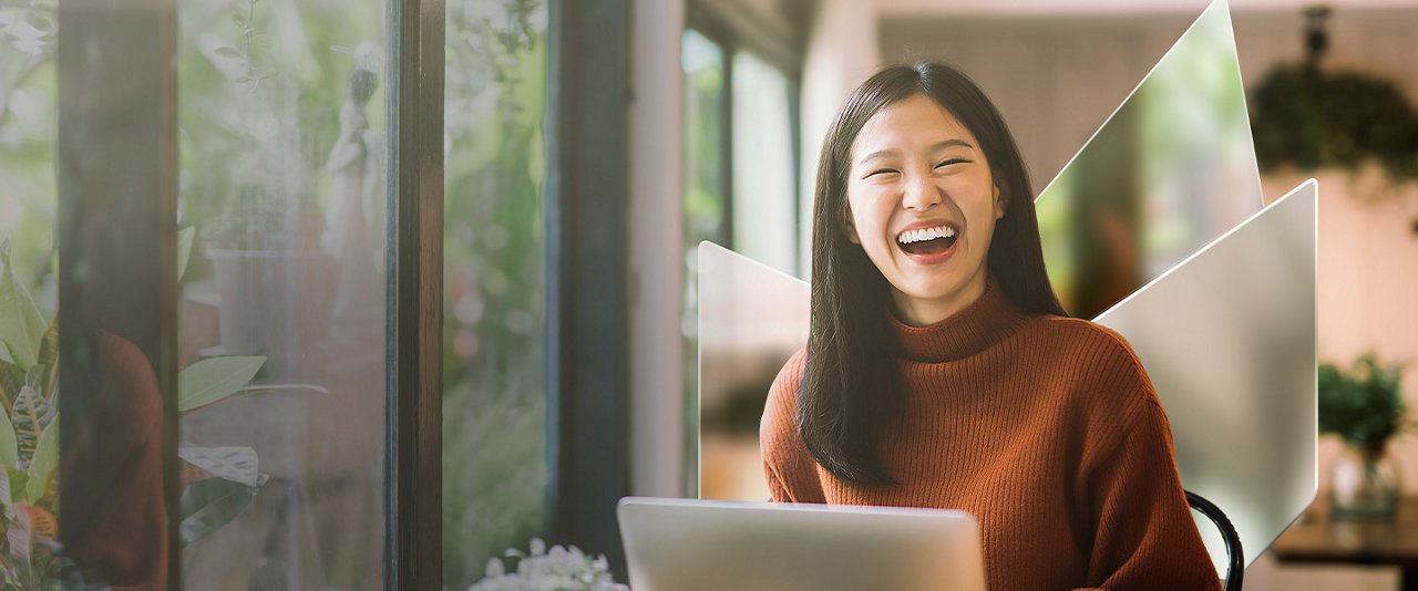 Lovely Asian girl and mother celebrating birthday with friends / family by having a virtual birthday party at home. Enjoying birthday celebration in front of the laptop during pandemic. Practicing social distancing. Birthday lifestyle theme