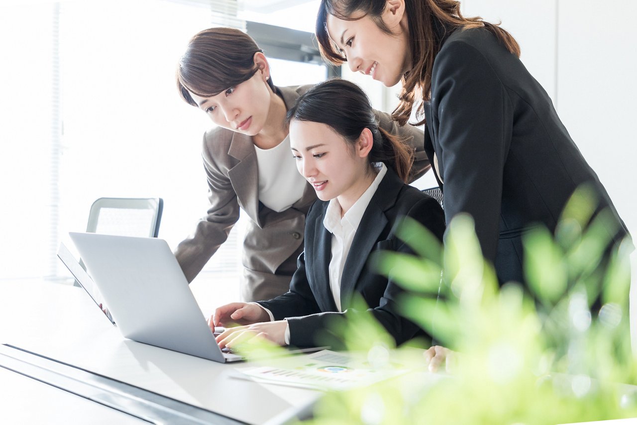 Three businesswomen working in the office. Positive workplace concept.