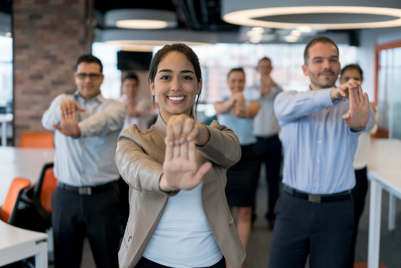 Office workers doing stretching exercises at the office 