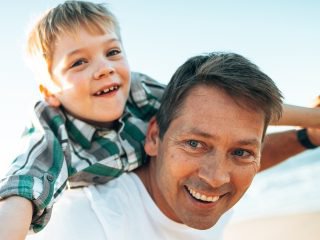 Son on dads back