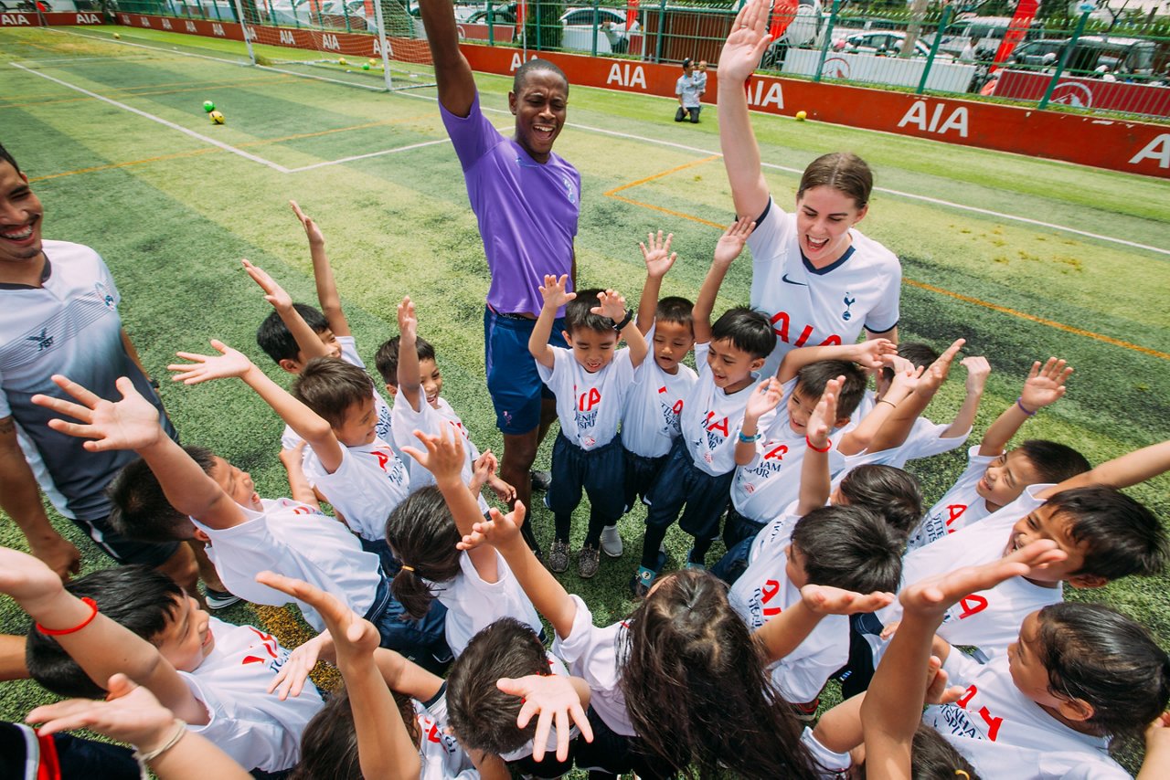 Tottenham Hotspur International Development Coach Anton Blackwood motivates kids at an AIA Coaching Clinic.