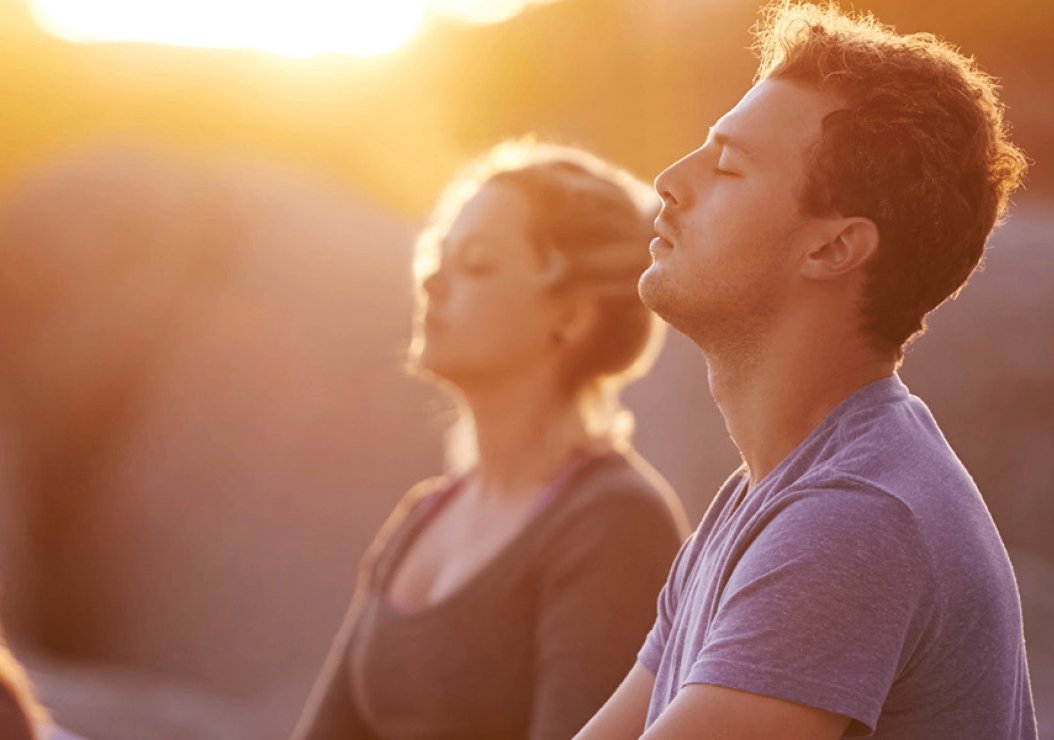 man and woman doing yoga