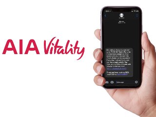 Hand holding phone with aia vitality message