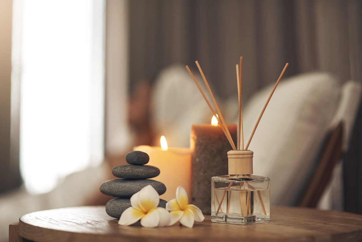 Diffuser, flowers, and scented candles at AIA Alta Wellness Haven exhibiting the calm, relaxing "Wellness Tasting Services" members will enjoy.