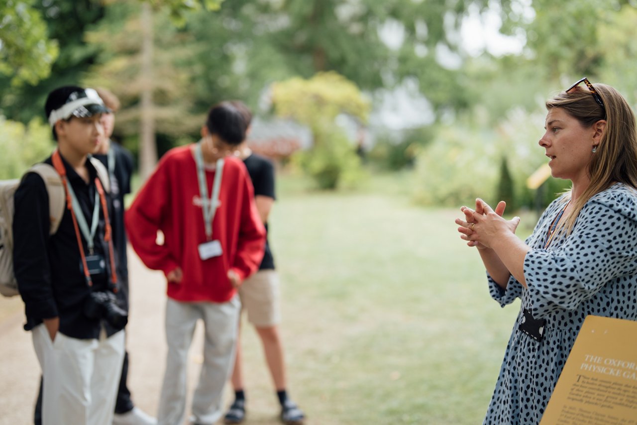 Lovely Asian girl and mother celebrating birthday with friends / family by having a virtual birthday party at home. Enjoying birthday celebration in front of the laptop during pandemic. Practicing social distancing. Birthday lifestyle theme