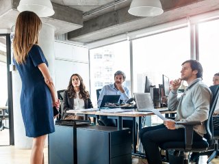 Men and women in boardroom having a meeting