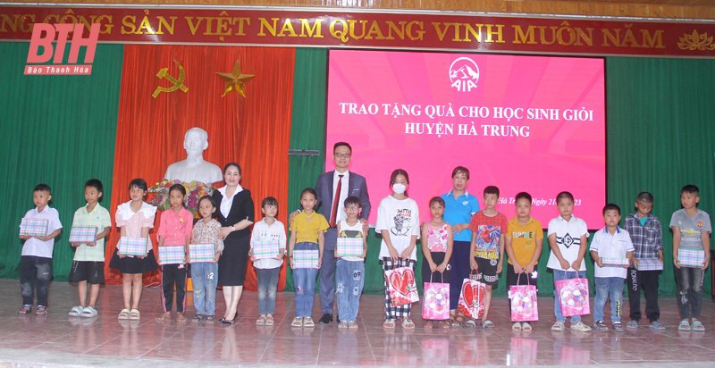 Ông Lê Đức Giang, Trưởng Kinh doanh khu vực cấp cao AIA Việt Nam và lãnh đạo Văn phòng Tổng đại lý AIA Thanh Hóa 1 và Bỉm Sơn cùng đại diện chính quyền địa phương trao quà cho các em học sinh.