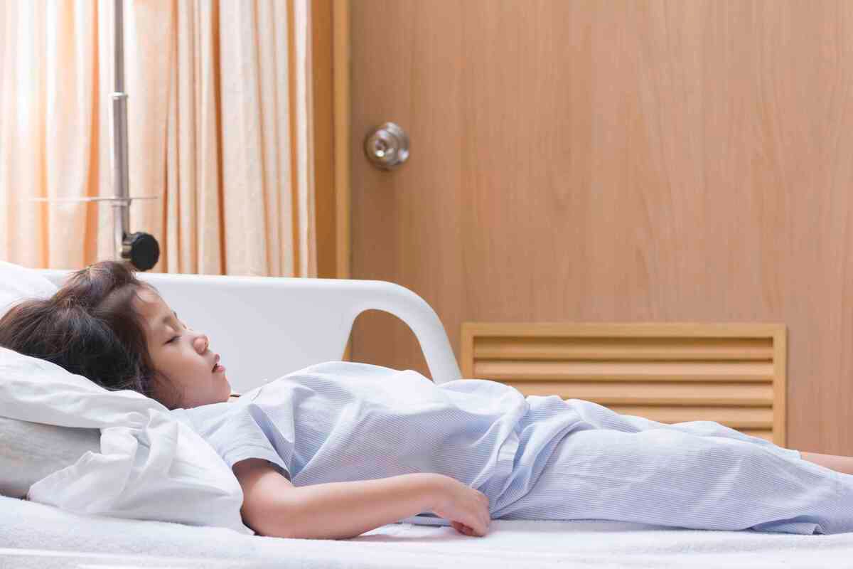 The Sick Cute Asian girl is recovering Sleep on patient Bed in the hospital.