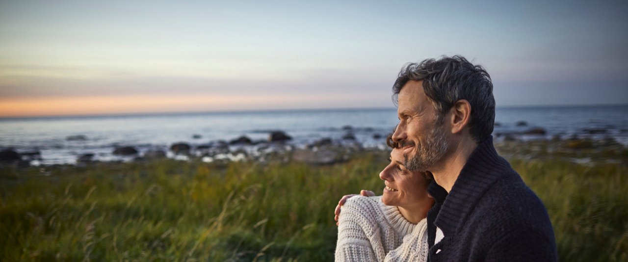 Couple embracing near water