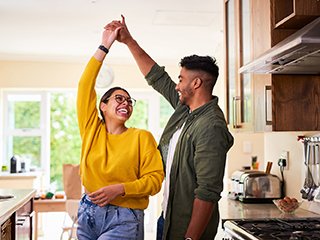 Couple dancing in kitchen