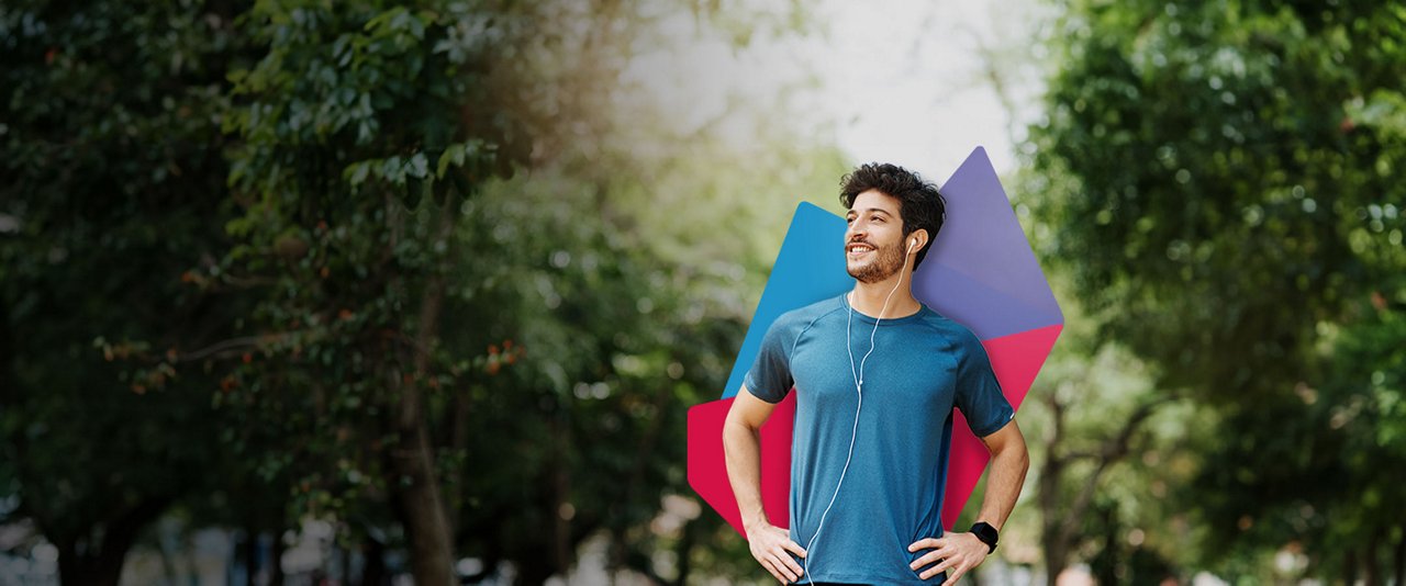 A male jogger wearing earphones stands outside.