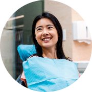 Woman smiling and sitting in a dentist chair