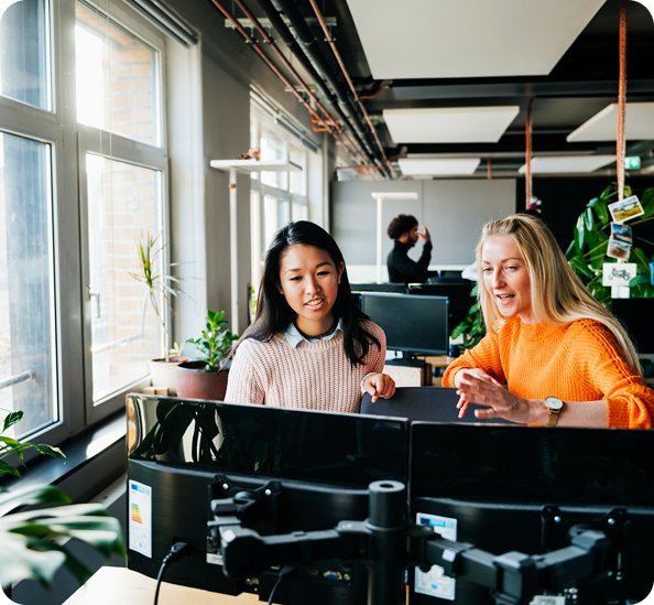 two women discussing about work in workplace