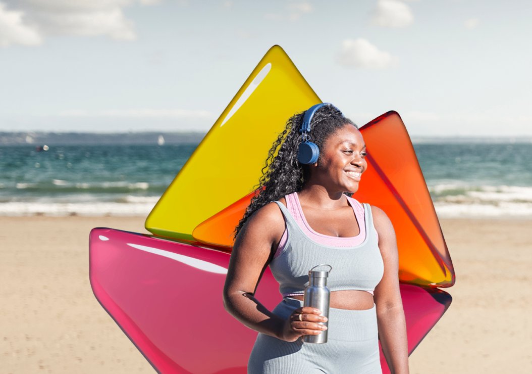 woman listening to music using headphone with bottle in hands