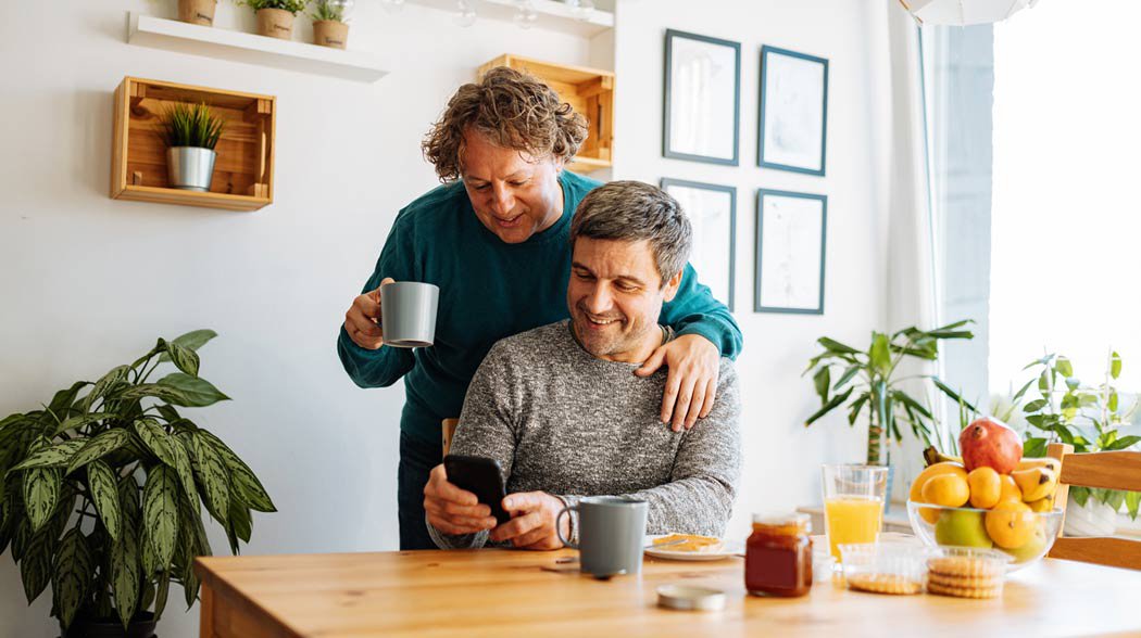 two man watching phone