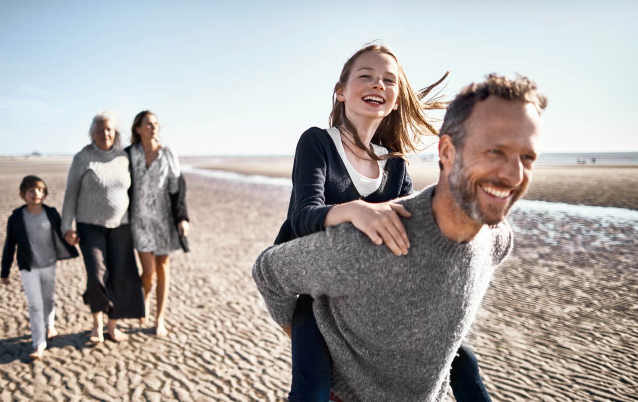 man carrying kid smiling