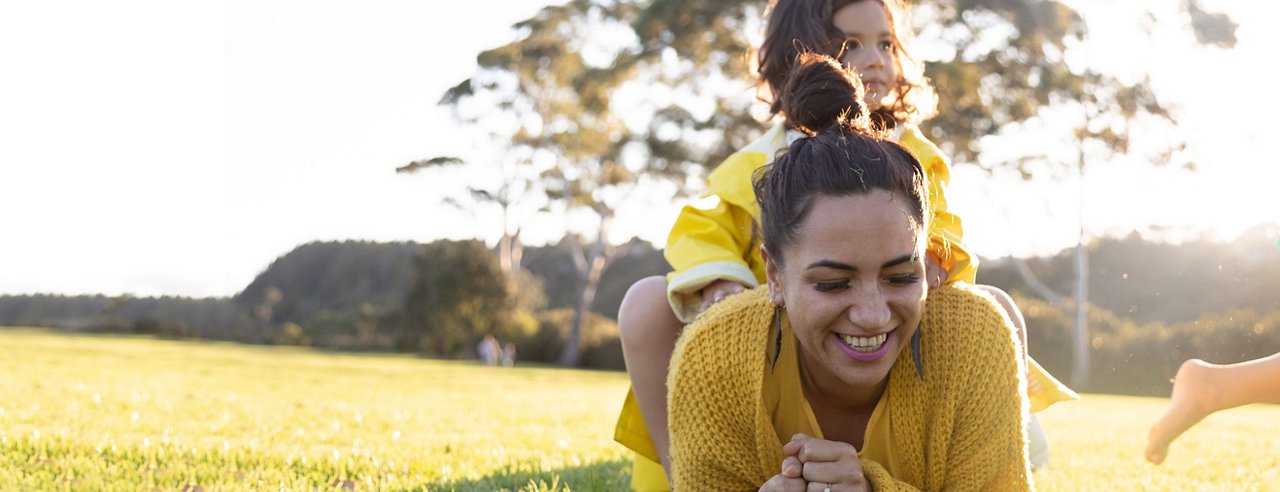 child sitting on top of woman