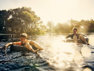 Dad and son on tubes in water