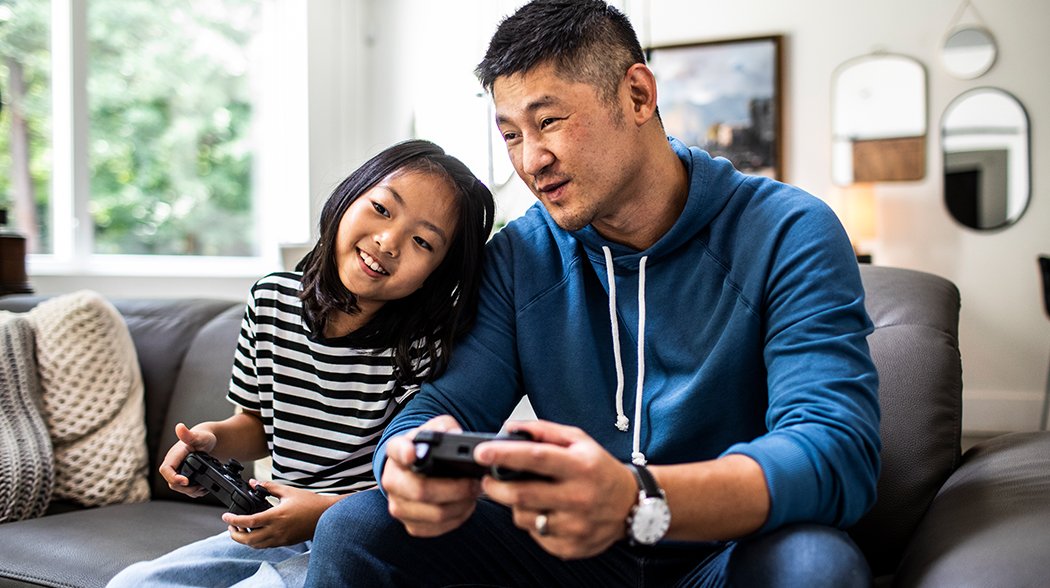 dad and daughter playing video game