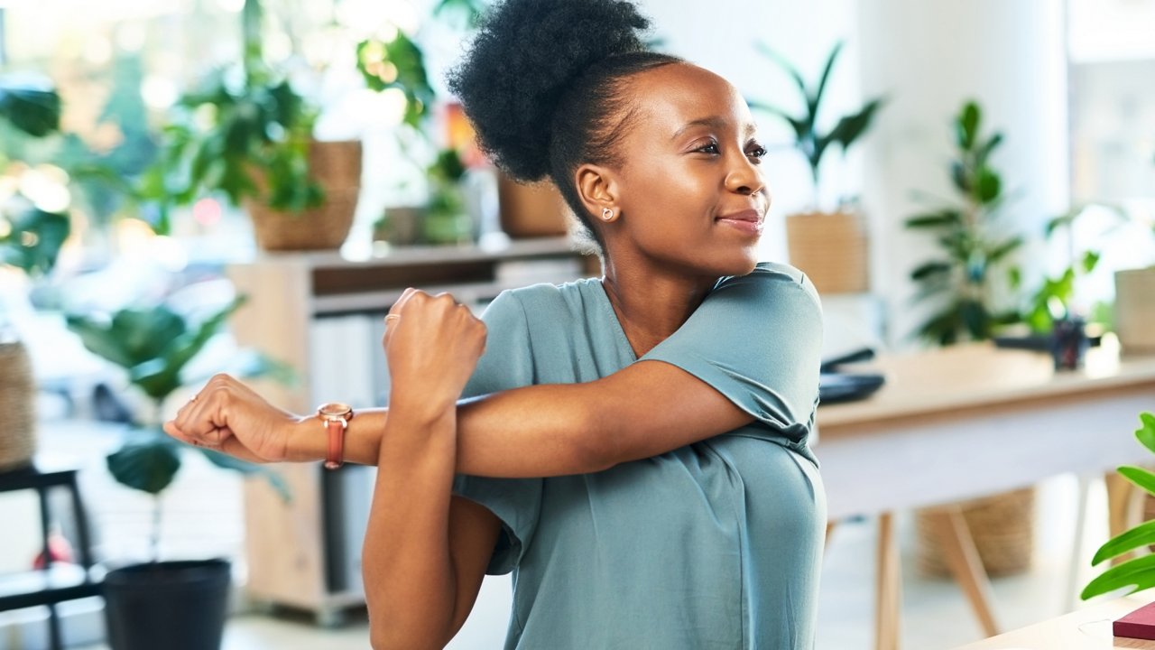 Woman doing exercise indoor surrounded ny plants