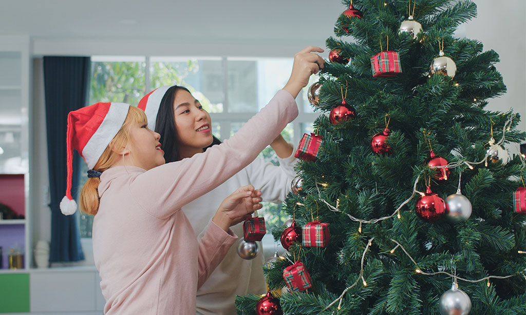  Young man using a laptop in a café, researching life insurance plans