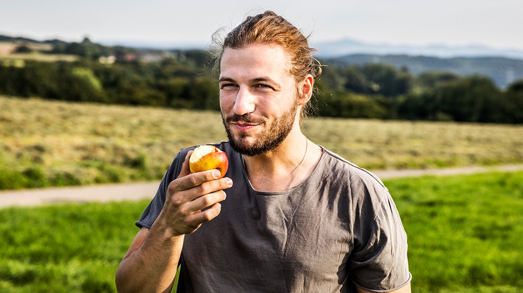 man eating apple