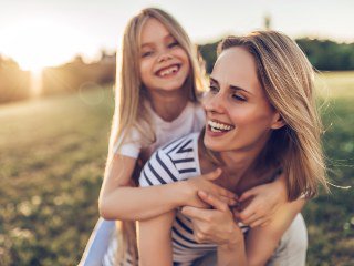 Mother with daughter on her back