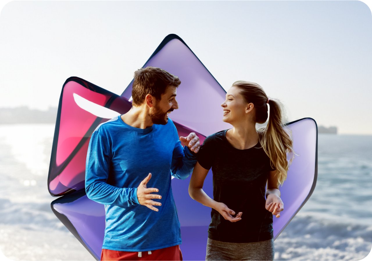 A man and woman stand side by side on a sandy beach