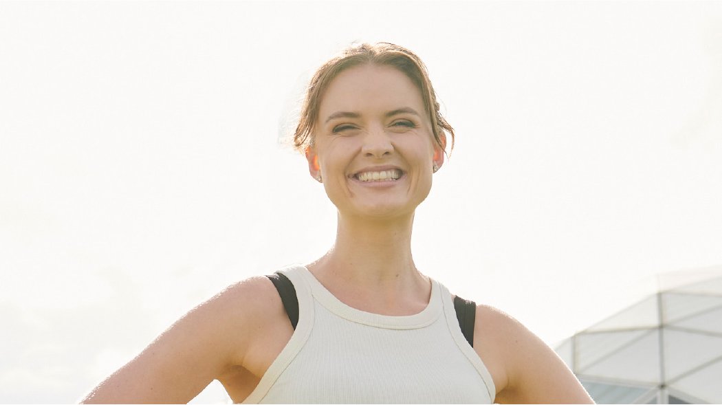 a woman standing and smiling