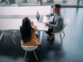 Two people sitting in a meeting