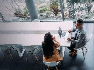 Two people at a table in an office