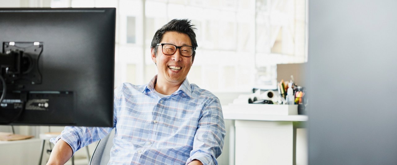 Male smiling at work desk