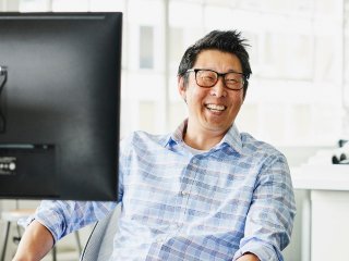 Male smiling at desk