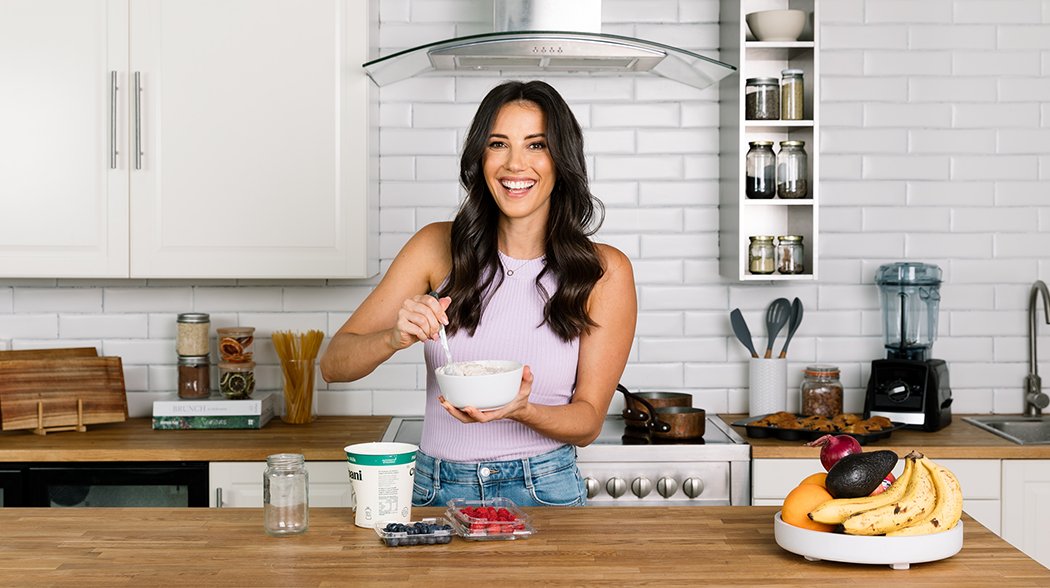 a woman preparing a dish in a kitchen