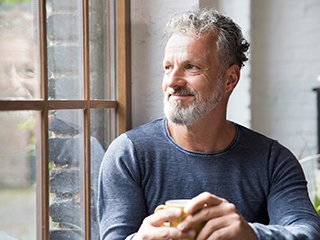 Male smiling while drinking coffee