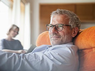 Older male sitting on couch