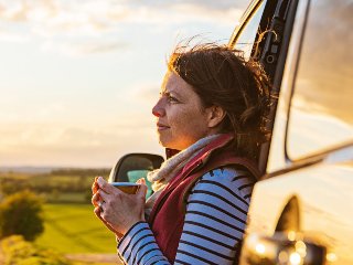 Lady looking out while drinking tea