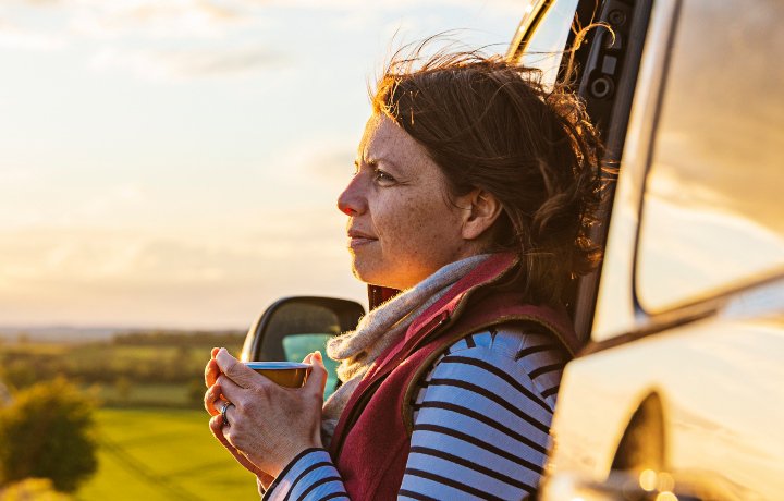 Lady looking out while drinking tea