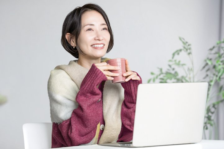 成熟人士正使用手提電腦並享用熱飲，象徵重視養生與健康管理。