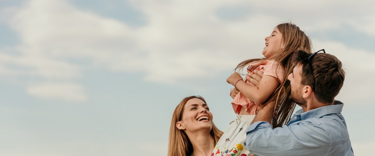 Family outdoors smiling