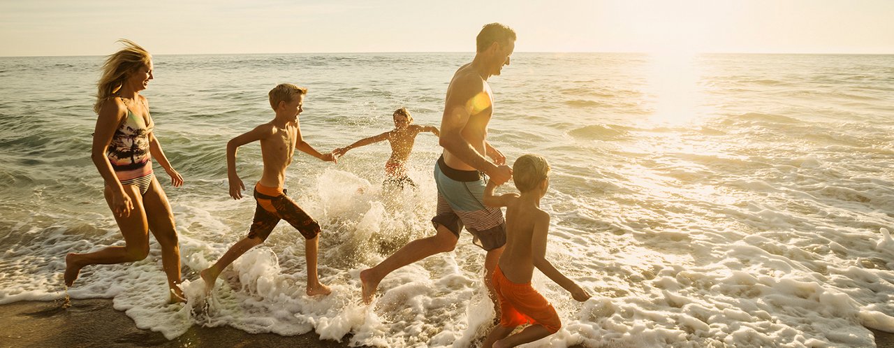 family running at the beach