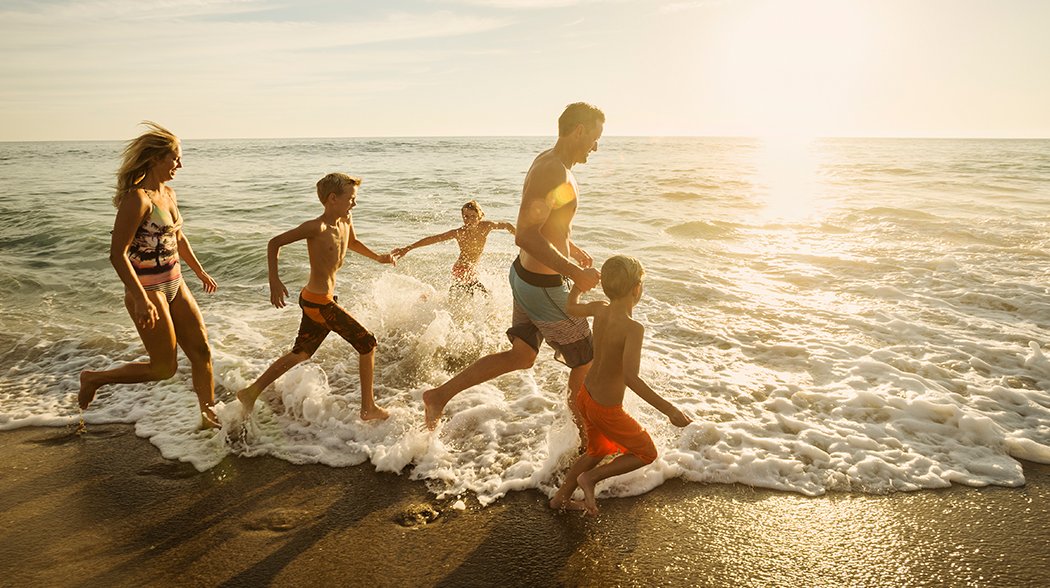 family playing in beach